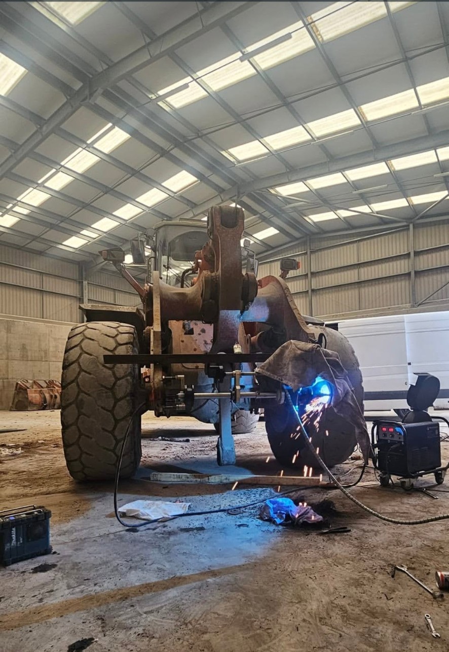 On-site line boring and welding repair to a loading shovel boom