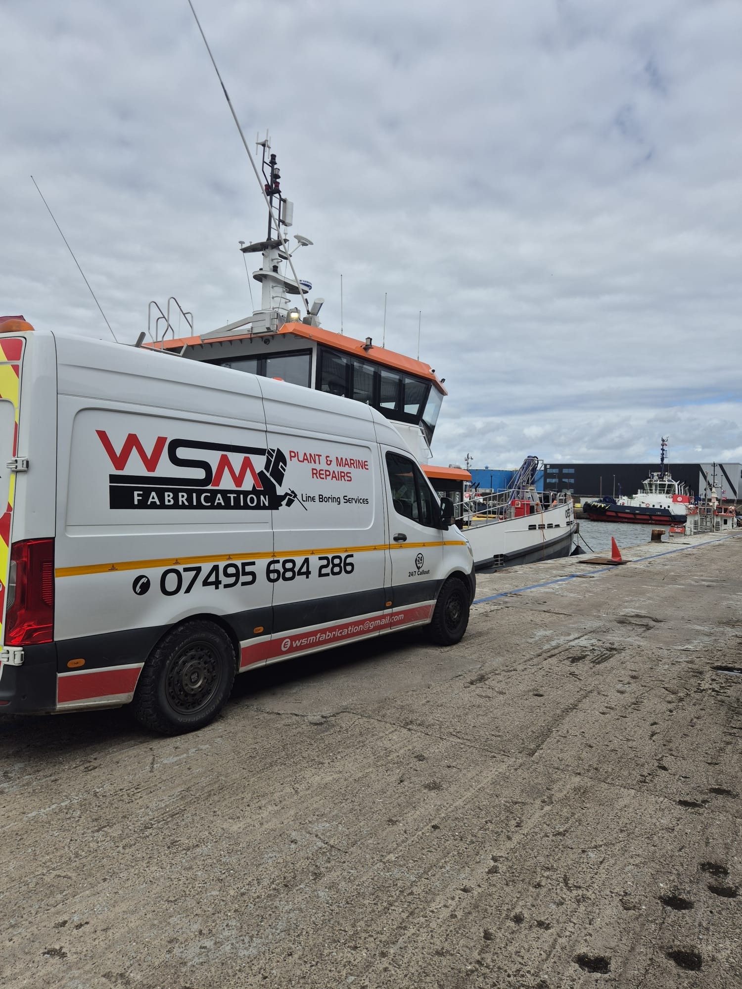 WSM Fabrication van on the quayside beside a workboat
